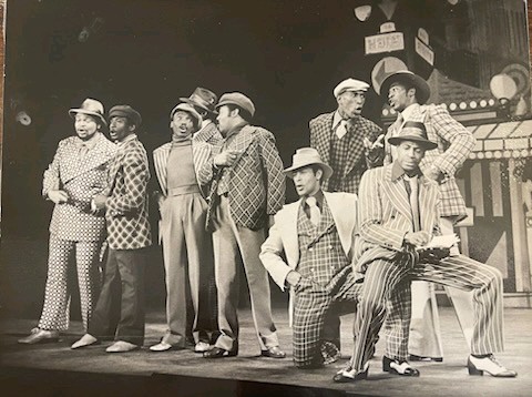 Andy Torres kneeling in the cast of Guys and Dolls